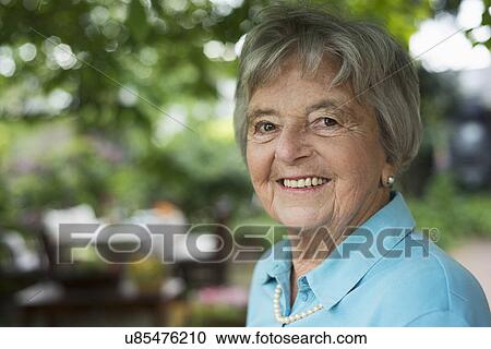 Senior woman in garden View Large Photo Image Stock Image - Senior woman in garden. Fotosearch
