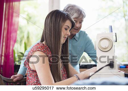 Senior woman watching granddaughter use sewing machine View Large Photo Image Stock Photo - Senior woman watching granddaughter use sewing machine. Fotosearch