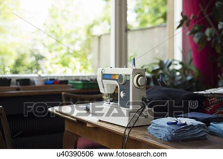 Sewing machine on table View Large Photo Image Stock Photograph - Sewing machine on table. Fotosearch