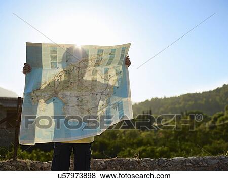 Stock Photo - Shadow of boy holding up a map, Majorca, Spain. Fotosearch