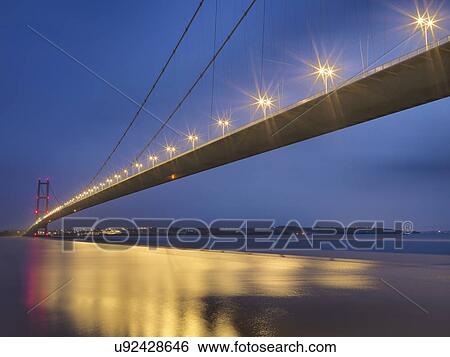 Stock Photograph - Suspension bridge at night. The Humber Bridge, UK was built in 1981 and at the time was the world's largest single-span suspension bridge. Fotosearch