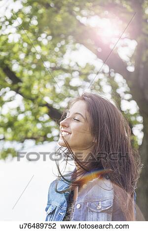 Stock Image - Teenager enjoying breeze. Fotosearch