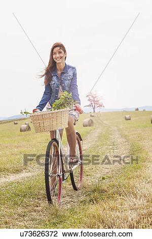 Teenager riding bicycle on field, Roznov, Czech Republic View Large Photo Image Stock Image - Teenager riding bicycle on field, Roznov, Czech Republic. Fotosearch