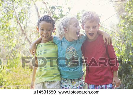 Three children in garden with arms around each other View Large Photo Image Stock Image - Three children in garden with arms around each other. Fotosearch