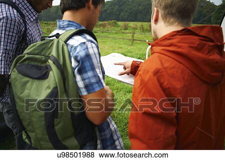 Stock Photo - Three men looking at map. Fotosearch