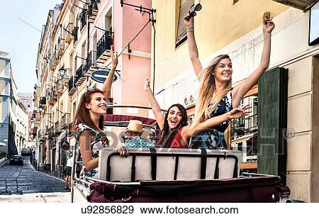 Three young women in open back seat of Italian taxi, Cagliari, Sardinia, Italy View Large Photo Image Stock Photo - Three young women in open back seat of Italian taxi, Cagliari, Sardinia, Italy. Fotosearch