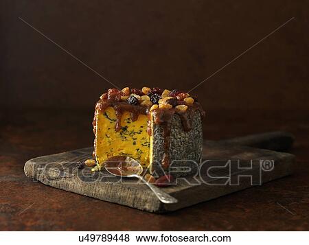 Stock Photo - Truckle of blacksticks blue cheese with glaze. Fotosearch