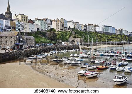 Stock Image - View of beach, harbor and boats, Tenby, Wales. Fotosearch