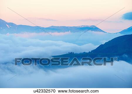 View of mountains above clouds at sunrise, Svaneti, Georgia View Large Photo Image Stock Image - View of mountains above clouds at sunrise, Svaneti, Georgia. Fotosearch