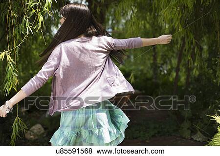 Woman dancing in garden View Large Photo Image Stock Photo - Woman dancing in garden. Fotosearch