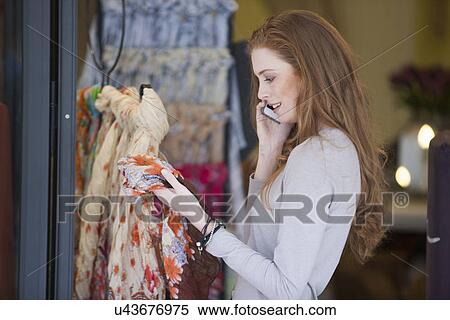 Woman on smartphone shopping for scarf View Large Photo Image Stock Photography - Woman on smartphone shopping for scarf. Fotosearch