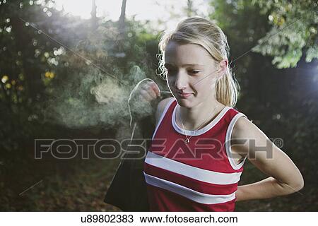 Woman putting on sweater in woods View Large Photo Image Stock Image - Woman putting on sweater in woods. Fotosearch