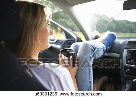 Woman sitting in car View Large Photo Image Stock Photograph - Woman sitting in car. Fotosearch