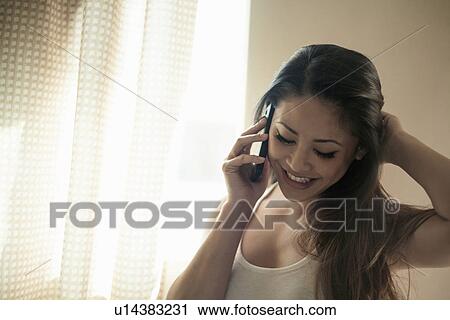 Woman talking on smart phone, smiling View Large Photo Image Stock Image - Woman talking on smart phone, smiling. Fotosearch