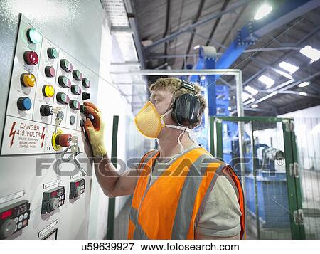 Worker at controls of metal ore grinding mill View Large Photo Image Stock Photo - Worker at controls of metal ore grinding mill. Fotosearch