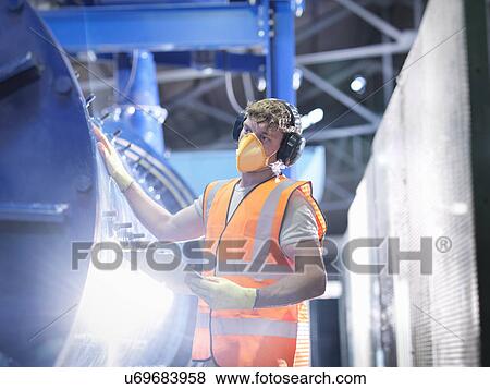 Worker checking metal ore grinding mill View Large Photo Image Stock Photo - Worker checking metal ore grinding mill. Fotosearch