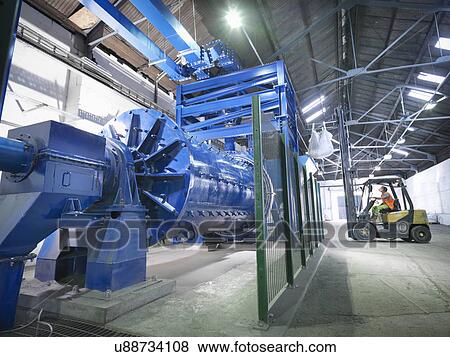 Worker in forklift truck loading metal ore in grinding mill View Large Photo Image Stock Photo - Worker in forklift truck loading metal ore in grinding mill. Fotosearch