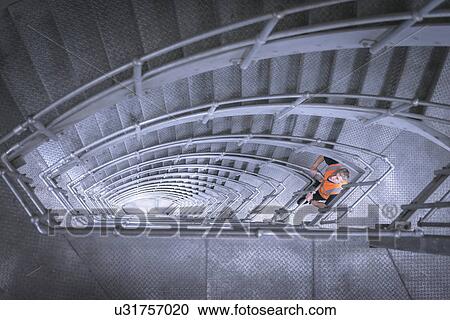 Stock Image - Worker in stairway of suspension bridge. The Humber Bridge, UK was built in 1981 and at the time was the world's largest single-span suspension bridge. Fotosearch