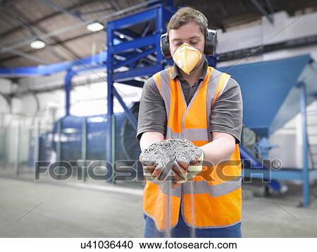 Worker with handful of ground metal ore in grinding mill View Large Photo Image Stock Image - Worker with handful of ground metal ore in grinding mill. Fotosearch