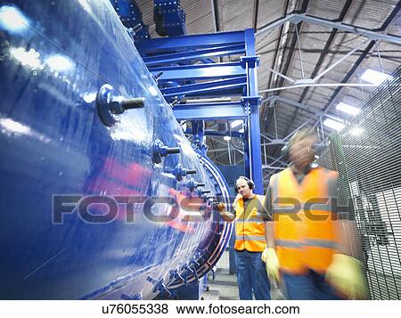 Workers checking metal ore grinding mill View Large Photo Image Stock Photo - Workers checking metal ore grinding mill. Fotosearch