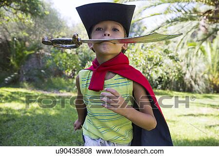 Young boy wearing fancy dress costume, running in park View Large Photo Image Stock Photo - Young boy wearing fancy dress costume, running in park. Fotosearch