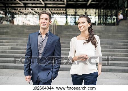 Young businesswoman and man chatting whilst walking, London, UK View Large Photo Image Picture - Young businesswoman and man chatting whilst walking, London, UK. Fotosearch