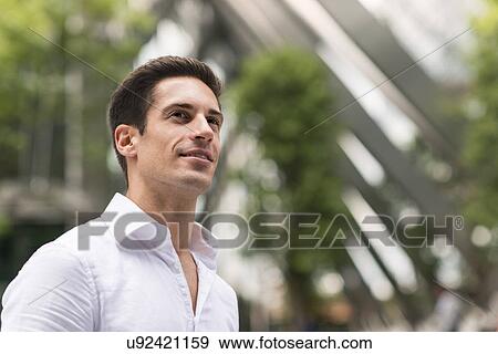 Stock Photo - Young confident businessman at Broadgate Tower, London, UK. Fotosearch