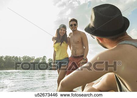 Young couple by lake View Large Photo Image Stock Photograph - Young couple by lake. Fotosearch