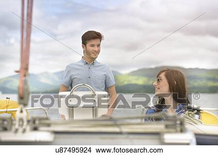 Picture - Young couple sailing on yacht over lake. Fotosearch
