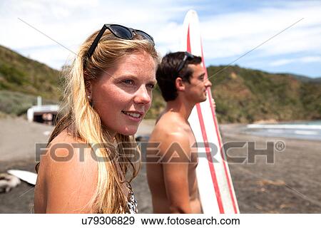 Young couple standing on beach looking out to sea View Large Photo Image Stock Photo - Young couple standing on beach looking out to sea. Fotosearch
