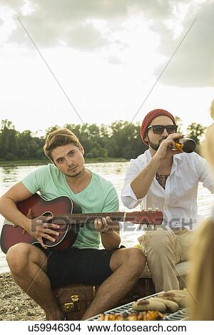 Picture - Young man playing guitar. Fotosearch