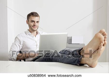 Young man working on laptop View Large Photo Image Picture - Young man working on laptop. Fotosearch