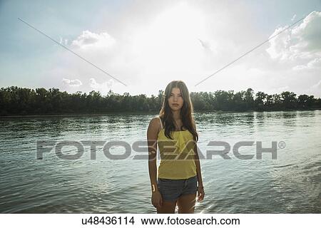 Young woman by lake View Large Photo Image Picture - Young woman by lake. Fotosearch