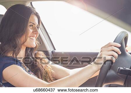 Stock Photo - Young woman driving car. Fotosearch