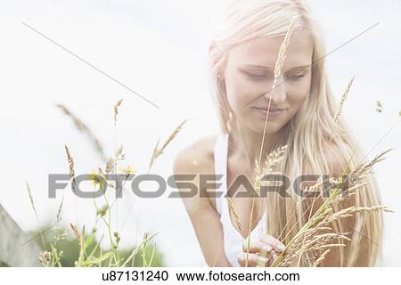 Stock Image - Young woman enjoying nature. Fotosearch
