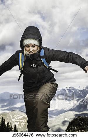 Stock Photograph - Young woman hiking in mountains, Hundsarschjoch, Vils, Bavaria, Germany. Fotosearch