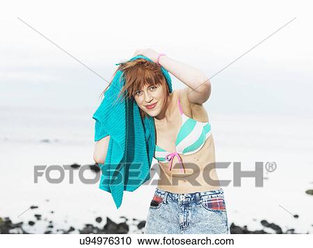 Young woman in bikini drying hair with towel, Williamstown beach, Melbourne, Australia View Large Photo Image Stock Image - Young woman in bikini drying hair with towel, Williamstown beach, Melbourne, Australia. Fotosearch