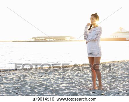 Young woman looking away on sunlit beach, Port Melbourne, Melbourne, Victoria, Australia View Large Photo Image Stock Photograph - Young woman looking away on sunlit beach, Port Melbourne, Melbourne, Victoria, Australia. Fotosearch