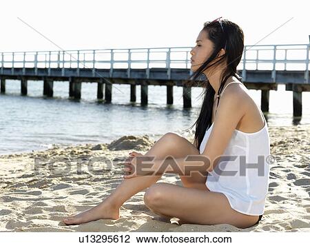 Young woman sitting looking away beach, Port Melbourne, Melbourne, Victoria, Australia View Large Photo Image Stock Image - Young woman sitting looking away beach, Port Melbourne, Melbourne, Victoria, Australia. Fotosearch