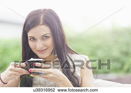 Young woman taking coffee break View Large Photo Image Stock Image - Young woman taking coffee break. Fotosearch