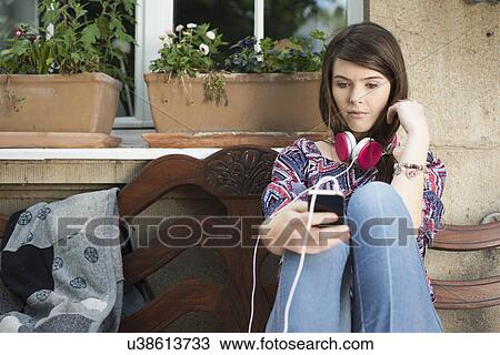 Young woman using mp3 player View Large Photo Image Stock Image - Young woman using mp3 player. Fotosearch