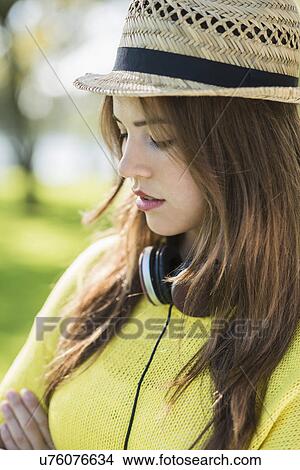 Picture - Young woman wearing straw hat, portrait. Fotosearch