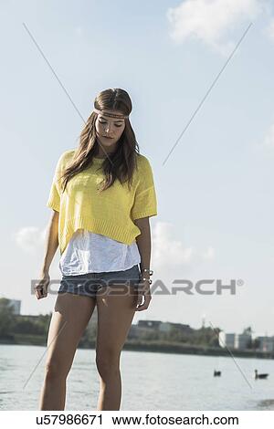 Young woman wearing yellow top and hot pants View Large Photo Image Stock Image - Young woman wearing yellow top and hot pants. Fotosearch