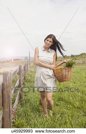 Young woman with basket of vegetable on field, Roznov, Czech Republic View Large Photo Image Stock Image - Young woman with basket of vegetable on field, Roznov, Czech Republic. Fotosearch