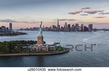 Aerial view of city with Statue of Liberty at sunset View Large Photo Image Stock Photography - Aerial view of city with Statue of Liberty at sunset. Fotosearch