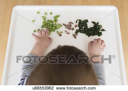 Baby girl (12-17 months) eating steak, spinach and green peas View Large Photo Image Stock Image - Baby girl (12-17 months) eating steak, spinach and green peas. Fotosearch