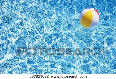 Stock Image - Beach ball in swimming pool. Fotosearch