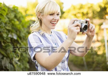 Blonde woman with digital camera View Large Photo Image Stock Photo - Blonde woman with digital camera. Fotosearch