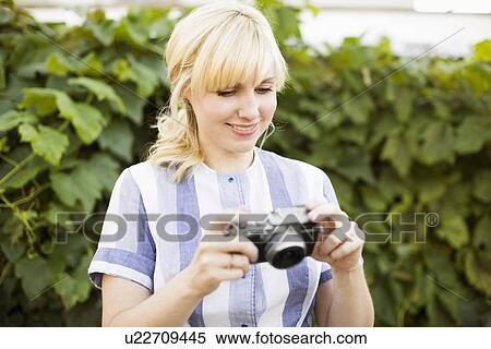 Blonde woman with digital camera View Large Photo Image Stock Photography - Blonde woman with digital camera. Fotosearch