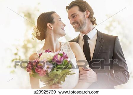 Stock Photo - Bride and groom celebrating their wedding. Fotosearch